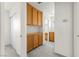 Hallway featuring built-in cabinetry and sliding door closet for ample storage space at 1540 Singing Bird Ln, North Las Vegas, NV 89031