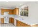 Bright kitchen featuring wooden cabinets, tile countertops, and a window offering natural light at 1540 Singing Bird Ln, North Las Vegas, NV 89031