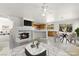 Inviting open floor plan featuring a fireplace and breakfast bar adjacent to the kitchen at 1540 Singing Bird Ln, North Las Vegas, NV 89031