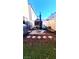 Cozy backyard with artificial grass, patio furniture, and a shade umbrella at 2131 Pillar Pointe St, Las Vegas, NV 89115