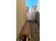 Exterior side yard with a wooden fence and stacked lumber along the property line at 2131 Pillar Pointe St, Las Vegas, NV 89115