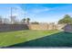 Spacious backyard featuring artificial turf, a brick wall, and a swing set, offering a safe and enjoyable outdoor space at 232 Delighted Ave, North Las Vegas, NV 89031