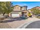Charming two-story home with a brick driveway, landscaped yard, and an attached two-car garage at 232 Delighted Ave, North Las Vegas, NV 89031