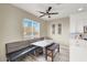 Inviting kitchen nook with built-in bench seating, a ceiling fan, and bright natural light at 232 Delighted Ave, North Las Vegas, NV 89031