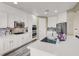 Bright and modern kitchen with stainless steel appliances, large island, and quartz countertops at 232 Delighted Ave, North Las Vegas, NV 89031