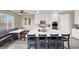 Bright kitchen featuring a large island, built-in booth seating, and stainless steel appliances at 232 Delighted Ave, North Las Vegas, NV 89031