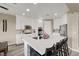 Modern kitchen boasts stainless steel appliances, quartz countertops, a large island, and seating at 232 Delighted Ave, North Las Vegas, NV 89031