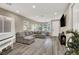 Bright living room featuring a white piano, comfortable sectional sofa, and television at 232 Delighted Ave, North Las Vegas, NV 89031