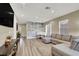 Inviting living room with wood-look floors, a modern accent wall, and comfortable sectional sofa at 232 Delighted Ave, North Las Vegas, NV 89031