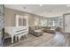 Bright living room featuring a white piano and comfortable sectional sofa at 232 Delighted Ave, North Las Vegas, NV 89031