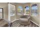 A cozy living room nook basks in natural light from the arched windows at 232 Delighted Ave, North Las Vegas, NV 89031