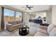 Bright living room featuring hardwood floors, large windows, and an open-concept design with views of the modern kitchen at 232 Delighted Ave, North Las Vegas, NV 89031
