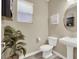 Cozy powder room featuring a pedestal sink, window, and decorative accents at 232 Delighted Ave, North Las Vegas, NV 89031