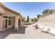 Backyard view of the home featuring patio and terraced landscaping at 2501 Maddington Dr, Las Vegas, NV 89134