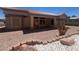 Inviting backyard featuring a covered patio, desert landscaping, and comfortable outdoor space at 2501 Maddington Dr, Las Vegas, NV 89134