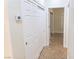 Hallway featuring tiled floor, white doors, and a sliding door closet at 2501 Maddington Dr, Las Vegas, NV 89134