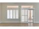 Living room features tiled floor and sliding glass door with plantation shutters at 2501 Maddington Dr, Las Vegas, NV 89134