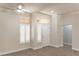 Bright living room features tile flooring, white walls, and plantation shutters at 2501 Maddington Dr, Las Vegas, NV 89134