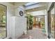 Bright atrium with skylights, brick flooring, potted plants, and interior access via sliding glass doors at 2531 La Cara Ave, Las Vegas, NV 89121