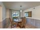 Cozy dining room with a round table, stylish chairs, and large window with natural light at 2531 La Cara Ave, Las Vegas, NV 89121