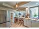 Open-concept kitchen featuring a breakfast bar with seating, stainless steel appliances and backyard access at 2531 La Cara Ave, Las Vegas, NV 89121
