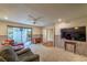 Inviting living room featuring comfy seating, a TV, and sliding door access to a private outdoor patio at 2531 La Cara Ave, Las Vegas, NV 89121