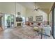 Elegant living room with high ceilings, fireplace, modern decor, and ample natural light at 2531 La Cara Ave, Las Vegas, NV 89121
