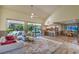 Bright living room features vaulted ceilings, comfortable seating, and access to the dining room and kitchen at 2531 La Cara Ave, Las Vegas, NV 89121