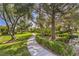 Serene community walking path surrounded by lush greenery and mature trees at 2531 La Cara Ave, Las Vegas, NV 89121