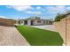 Spacious backyard featuring artificial turf, hardscape, and block wall fencing for added privacy at 3005 Merlesco Ave, Henderson, NV 89044