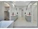 This modern bathroom features dual vanities, a glass-enclosed shower, and a view into the closet at 3005 Merlesco Ave, Henderson, NV 89044