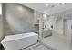 This modern bathroom features a tub, a glass-enclosed shower, and a vanity at 3005 Merlesco Ave, Henderson, NV 89044