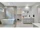 This spacious bathroom features a modern tub, a glass-enclosed shower, and a vanity with double sinks at 3005 Merlesco Ave, Henderson, NV 89044