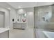 This spacious bathroom features a modern glass shower, and a vanity with double sinks at 3005 Merlesco Ave, Henderson, NV 89044