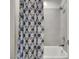 Bathroom showing the blue-patterned shower curtain and white tiled walls at 3005 Merlesco Ave, Henderson, NV 89044