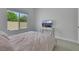 Calm bedroom with a neutral palette, a large window, and a sleek media console at 3005 Merlesco Ave, Henderson, NV 89044