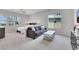 Spacious bedroom features a seating area, large windows, and neutral carpeting, creating a comfortable retreat at 3005 Merlesco Ave, Henderson, NV 89044
