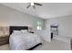 Spacious bedroom with neutral colors, a comfortable bed, and tasteful decor, perfect for restful nights at 3005 Merlesco Ave, Henderson, NV 89044