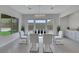 Bright dining area with a contemporary glass table and stylish white chairs at 3005 Merlesco Ave, Henderson, NV 89044