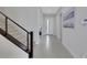 Bright foyer featuring sleek tile flooring, modern staircase with metal railings, and a white front door at 3005 Merlesco Ave, Henderson, NV 89044