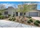 Modern home with xeriscaping, low-water plants, neutral palette, and an attached two-car garage at 3005 Merlesco Ave, Henderson, NV 89044
