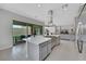 Open kitchen featuring a large center island with cooktop, stainless steel refrigerator, and backyard access at 3005 Merlesco Ave, Henderson, NV 89044