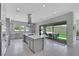 Spacious kitchen features an island with seating, stainless steel appliances, and access to the backyard patio at 3005 Merlesco Ave, Henderson, NV 89044