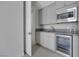Stylish kitchenette boasts granite countertops, stainless steel microwave and refrigerator, and gray cabinets at 3005 Merlesco Ave, Henderson, NV 89044