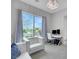Stylish living room with a large window, contemporary chandelier, comfortable seating, and office desk at 3005 Merlesco Ave, Henderson, NV 89044