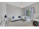 Bright living area featuring neutral tones, a modern chandelier, a large window, and comfortable seating at 3005 Merlesco Ave, Henderson, NV 89044