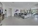 Open concept living area with a gray sectional sofa, tile flooring, and kitchen view at 3005 Merlesco Ave, Henderson, NV 89044