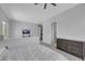 Bright main bedroom featuring a ceiling fan, a mounted tv, neutral walls, and a gray dresser at 3005 Merlesco Ave, Henderson, NV 89044