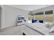 Bright main bedroom featuring a large bed, bench, mirrored dresser and large window at 3005 Merlesco Ave, Henderson, NV 89044