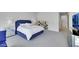 Spacious main bedroom featuring a blue bed, mirrored nightstands, and a modern dresser at 3005 Merlesco Ave, Henderson, NV 89044